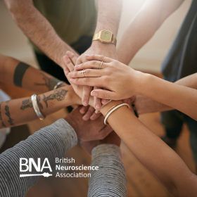 Promotional image featuring a group of people putting their hands together in the centre of a circle – a gesture often associated with teamwork, unity, and collaboration. There's also a logo in the corner for the British Neuroscience Association (BNA).