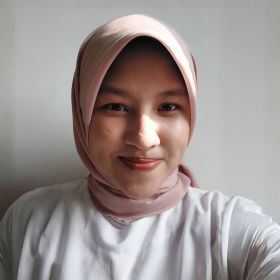 Muthia Huda Islami - DEMENTIA RESEARCHER Close-up portrait of a smiling woman wearing a pink hijab and white shirt against a light background.