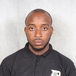 Oluwatosin Olubanke, software engineer, wearing a black polo shirt against a grey background.