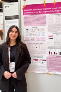Sofianna Nouka Pinterest Pin Sofianna Nouka standing in front of research posters at a conference.